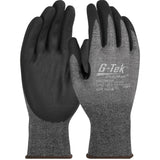 A pair of PIP G-Tek PolyKor Gloves by Protective Industrial Products features black nitrile-coated foam grips on the palms and gray fabric on the back. Designed for durability, grip, and touchscreen compatibility, these gloves also come with printed text and branding.