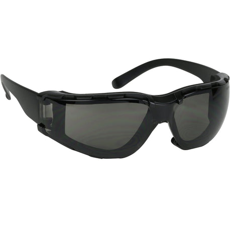 The PIP Bouton Zenon Z11SM Foam Safety Glasses feature a sleek black frame with tinted lenses in a wraparound design. The frame is equipped with side ventilation slits for added protection and comfort, all enhanced by an anti-scratch coating. These safety glasses meet ANSI Z87.1+ standards, ensuring reliable durability. Pack includes 12 pairs per box from the trusted brand PIP - Protective Industrial Products.