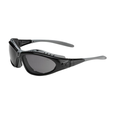 The PIP Fuselage Safety Glasses, Anti-Fog 250-50-042, offered in a pack of 6 pairs by Protective Industrial Products, boast a sleek aerodynamic design with black frames and dark lenses. They feature gray temple arms and adjustable nose pads for added comfort, along with an anti-fog coating ensuring clear vision during outdoor activities.