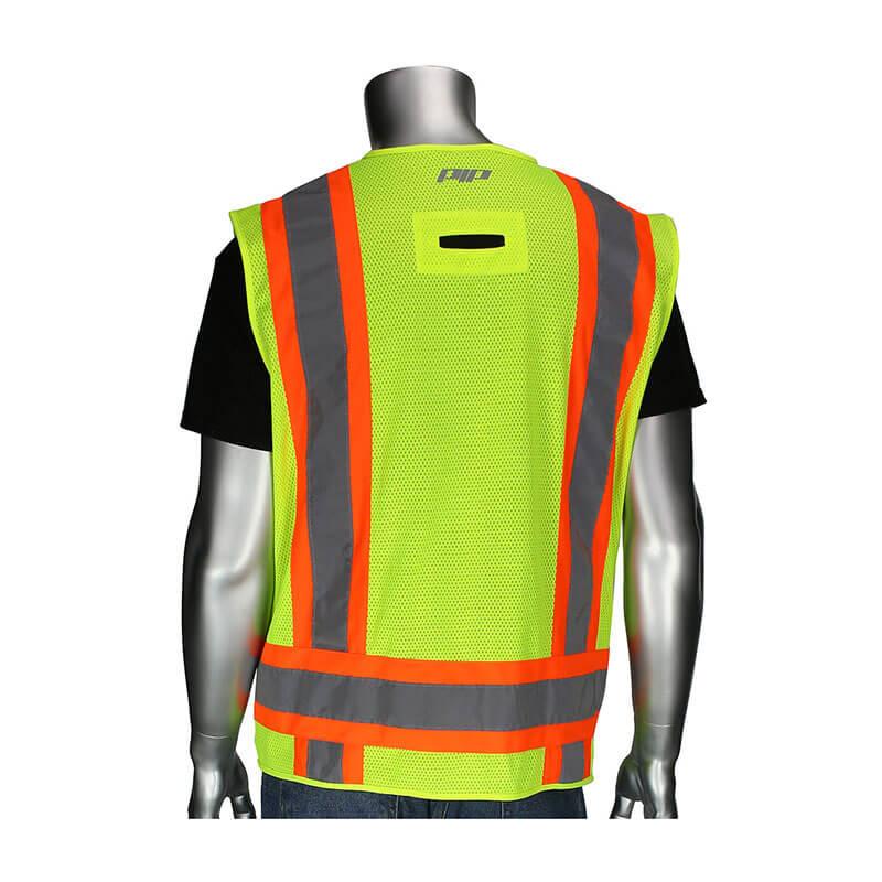 A silver mannequin displays the PIP Two-Tone Surveyors Vest w/D-Ring, a striking piece of hi-visibility apparel in neon yellow with orange and reflective gray stripes, set against a plain white background. This vest, from PIP - Protective Industrial Products, is classified as ANSI Type R Class 2 and includes a Velcro patch opening on the upper back for added convenience.