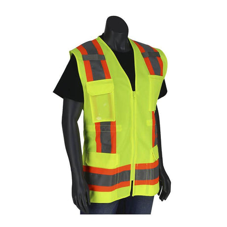 A mannequin displays the PIP Type R Class 2 Women's Contoured Two-Tone Surveyors Vest 302-0512 in Hi-Vis Yellow, made by Protective Industrial Products (PIP). This neon yellow safety vest meets ANSI Type R Class 2 standards and is designed with orange and gray reflective stripes. Worn over a black shirt, it features multiple pockets and a front zipper for added practicality.