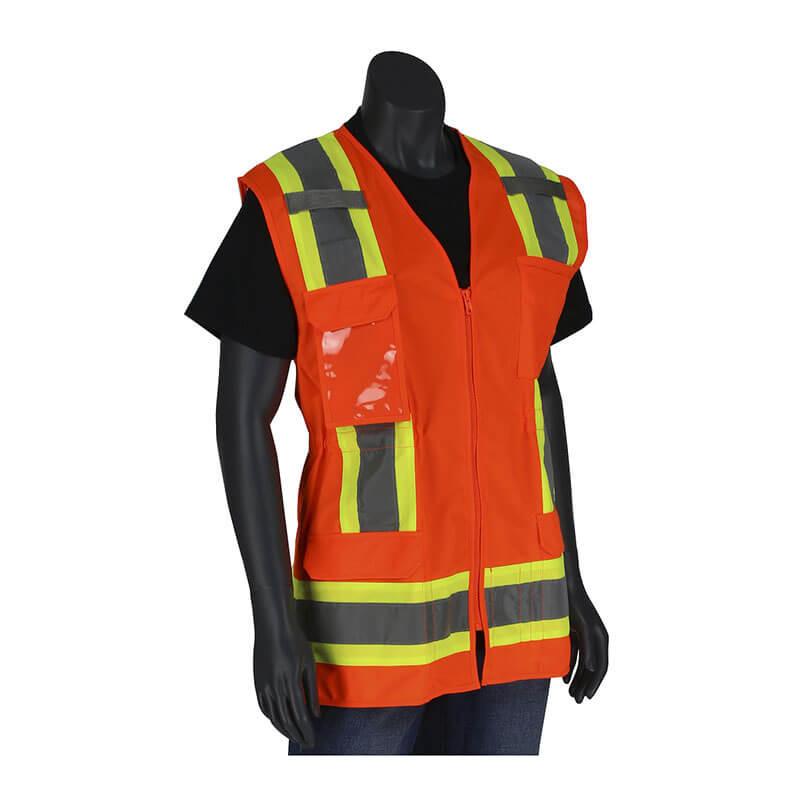 A mannequin showcases the PIP Type R Class 2 Women's Contoured Two-Tone Surveyors Vest 302-0512 by Protective Industrial Products, featuring a vibrant orange design with yellow reflective stripes over a black shirt. This ANSI Type R Class 2 vest is equipped with multiple pockets and zippers, providing both functionality and high-visibility safety compliance.