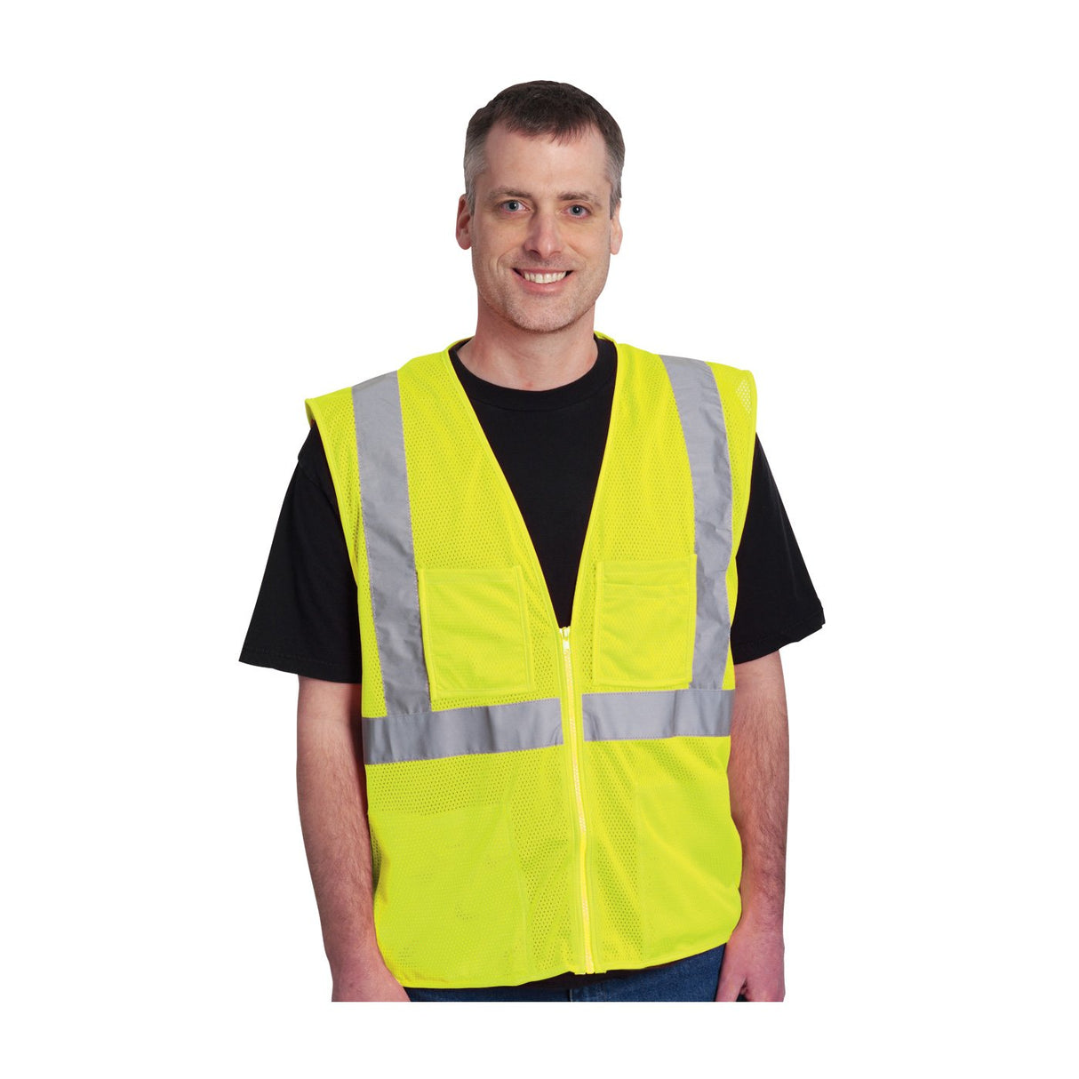 A man wearing the PIP ANSI Type R Class 2 Four Pocket Mesh Vest 302-MVGZ4P smiles at the camera. The bright yellow vest from Protective Industrial Products, featuring gray reflective tape and crafted from breathable mesh, is worn over a black shirt and includes two large pockets. His short gray and brown hair stands out against the white background.