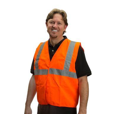 A person smiling while wearing a PIP Class II Orange Reflective Traffic Vest 302-WCENGOR with reflective stripes over a black shirt. The background is plain white.