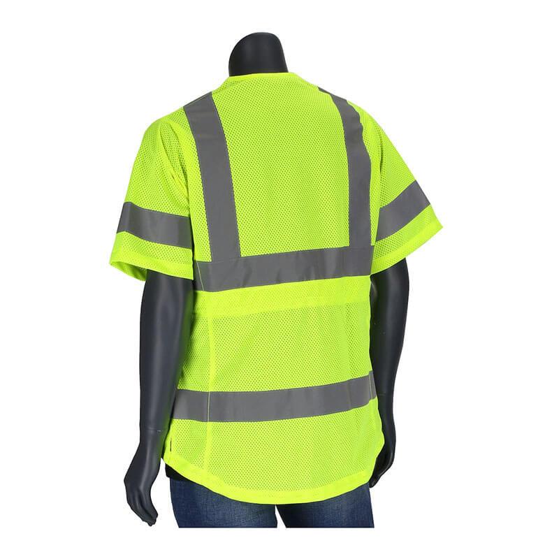 A mannequin showcasing a PIP ANSI Type R Class 3 Women's Contoured Vest 303-0313, featuring a yellow high-visibility design with gray reflective stripes, is paired with blue jeans. As part of essential traffic safety equipment from PIP - Protective Industrial Products, this vest ensures maximum visibility. The background is plain white.