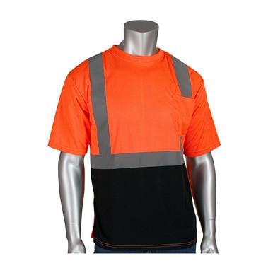 A mannequin showcases the PIP Class 2 UV Black Bottom Crew Neck T-Shirt 312-1250B-OR by Protective Industrial Products, featuring UPF 50+ protection. The shirt is designed with a high-visibility orange upper section accented with reflective gray stripes and a black bottom half. It includes short sleeves, a crew neckline, and adheres to ANSI Class 2 standards.