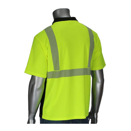 A mannequin displays the PIP ANSI Type R Class 2 Hi-Vis Polo Sleeve Polo Shirt 312-1610B from Protective Industrial Products. This bright yellow polo shirt features moisture control fabric and breathable reflective tape on the back and shoulders. With its black collar and side panels, it pairs seamlessly with blue jeans, combining style with functionality.