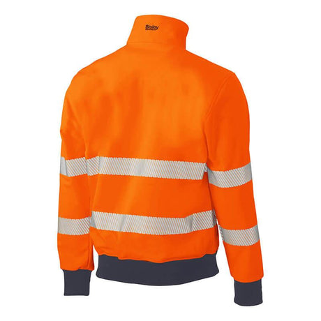 Introducing the PIP Bisley ANSI Type R Class 3 Soft Shell Jacket 333M6979T by Protective Industrial Products. This high-visibility jacket comes in a vibrant orange color and is enhanced with reflective stripes on the back and sleeves, providing superior visibility. It also features a folded collar and elastic cuffs to ensure safety and comfort in low-light environments.