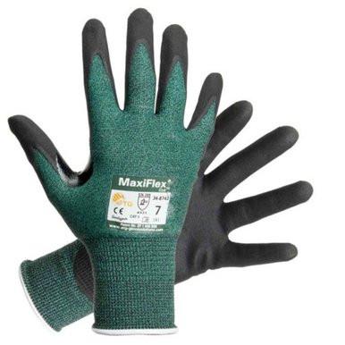 Two green PIP ATG MaxiFlex Cut Resistant Gloves 34-8743, featuring black nitrile-coated palms, demonstrate their durability. The tag on one glove provides information about safety and size details. Positioned to display both the palms and backs, they clearly highlight their design and protective features.