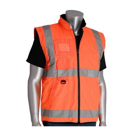 A mannequin showcases the PIP All Conditions Coat, Inner Jacket & Vest Combo 343-1756 by Protective Industrial Products. The ensemble features an ANSI Type R Class 3 orange high-visibility safety vest with reflective gray stripes over a black shirt. Designed with a zipper front and pockets, this vest is crafted from waterproof polyester to enhance safety in demanding work environments.