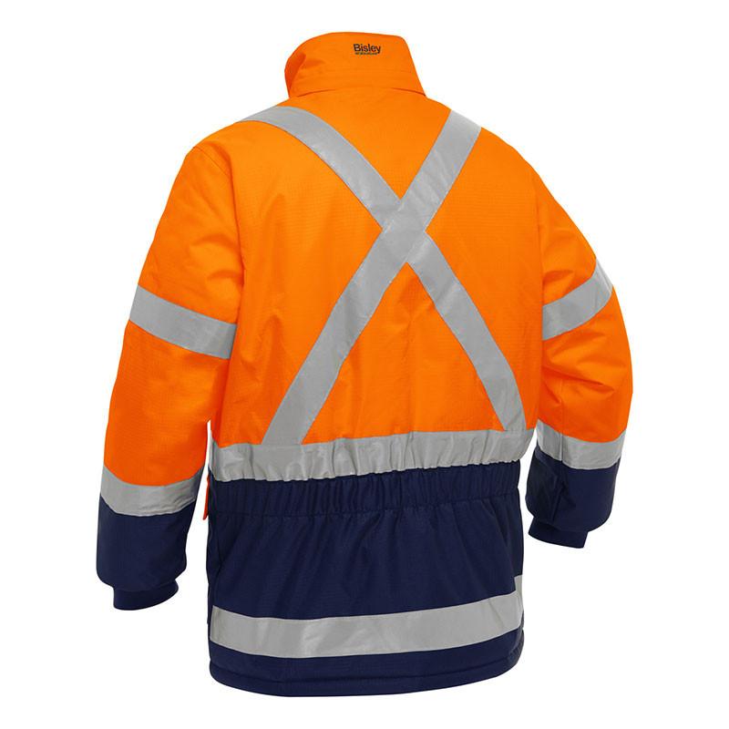 The PIP Bisley X-Back Extreme Cold Jacket w/Navy Bottom 343M6450X by Protective Industrial Products is an orange hi-vis jacket that includes reflective silver stripes and a navy-blue waistband and cuffs. It is designed for extreme cold protection, featuring thermal insulation, a cross pattern on the back for enhanced visibility, and a high collar.