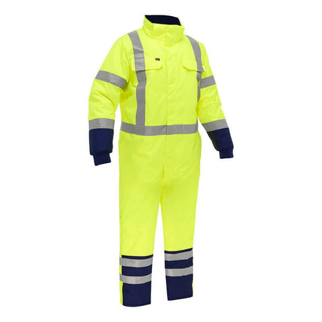 The PIP Bisley Extreme Cold Coverall with X-Back 344M6453X, by Protective Industrial Products, is showcased in a high-visibility yellow color featuring silver reflective bands. It includes navy blue cuffs and ankles with extra reflective stripes near the hems to offer thermal protection and enhance safety in extreme cold conditions.