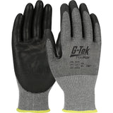 Shown here is a pair of PIP G-Tek PolyKor Blended Gloves, featuring a black and gray design. The palm and fingers are coated for a smooth grip, while the back and wrist remain gray accented with a yellow cuff. These gloves boast ANSI A5 cut resistance along with brand protection specifications from PIP - Protective Industrial Products, and they offer touchscreen compatibility.