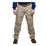 A person wearing GRIT FR Cargo Pants by GRIT FR Workwear with a brown belt, a navy long-sleeve shirt, and brown shoes stands against a plain white background.