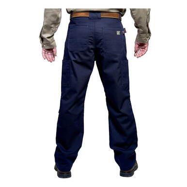 A person wearing GRIT FR Cargo Pants in navy blue, complemented by a brown belt and a beige shirt, is viewed from the back. The durable pants from GRIT FR Workwear boast multiple pockets, and the ensemble is completed with black shoes.