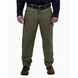 A person wearing GRIT FR Carpenter Pants in Green Duck, paired with a black belt, a dark long-sleeve shirt, and brown shoes stands against a plain white background. The pants feature multiple pockets and are crafted from durable GRIT 8.5 oz. fabric by the brand GRIT FR Workwear.