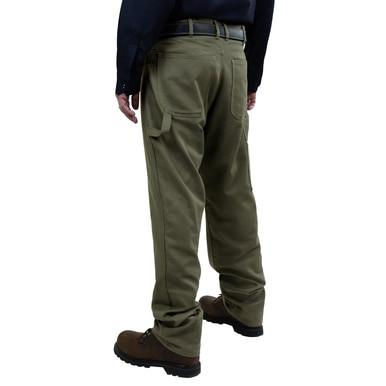 A person wearing the GRIT FR Carpenter Pants in Green Duck by GRIT FR Workwear, along with a black shirt and brown shoes, stands facing away. These 8.5 oz pants, designed for work wear, feature multiple pockets and are paired with a sleek black belt against a plain white background.