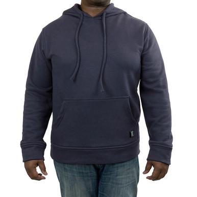 The person is wearing a GRIT FR Pullover Hoodie from GRIT FR Workwear in dark gray, featuring flame-resistant material, a front pocket, and drawstrings. It's paired with blue jeans. The hoodie looks comfortable and casual, ideal for everyday wear while providing the added safety of apparel designed for electrical work.