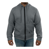 A person wearing a grey GRIT FR Zip-Up Hoodie by GRIT FR Workwear, specifically crafted for worker safety specialists with its flame-resistant fabric. This hoodie features a zip-up design, drawstrings, and a small logo near the pocket, and is paired with blue jeans against a plain white background.