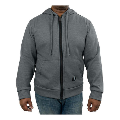 A person confidently stands against a plain white background, embodying the expertise of worker safety specialists while wearing a GRIT FR Zip-Up Hoodie from GRIT FR Workwear, complete with drawstrings and front pockets, paired with blue jeans.