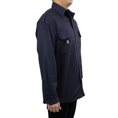 A person is wearing a GRIT FR Twill Work Shirt Navy by GRIT FR Workwear, featuring flap pockets on the chest and designed for professionals. The flame-resistant shirt is paired with black pants. The image captures the individual's left profile from the side view.