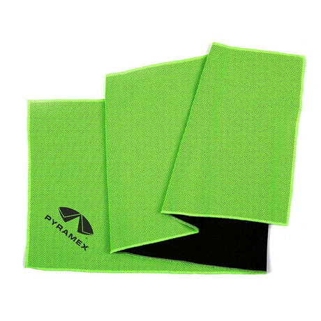 A folded Pyramex Safety C3 Series Cooling Towel features a vibrant bright green exterior with a small black "Pyramex" logo in the corner. Its moisture-wicking black interior not only adds contrast but also provides UPF 50+ protection.