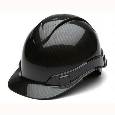 The Pyramex Safety Hydro Dipped Ridgeline Cap Style hard hat offers a glossy black finish with a carbon fiber texture, featuring a sleek, low-profile design and an adjustable strap, as well as 4-position harness points for optimal comfort.