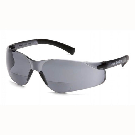 The Pyramex Ztek Reader Safety Glasses feature sleek, wraparound design with dark-tinted lenses and black frames, offering UVA/B/C protection. The scratch-resistant temples are adorned with the "Zitek Readers" label in white text.