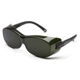 A pair of Pyramex OT Welding Safety Glasses S35_0SFJ featuring a sleek design with dark green lenses and thick frames. The black arms have a shiny finish, and the glasses include an IR filter lens for enhanced protection.