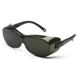 Introducing the Pyramex OT Welding Safety Glasses S35_0SFJ by Pyramex Safety, featuring a stylish pair of dark green sunglasses with thick black arms and an oval lens shape. The frames boast a shiny finish and are equipped with an IR filter lens for enhanced protection. Additionally, the arms highlight a unique hinge design that seamlessly blends style and functionality.