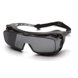 The Pyramex Cappture Safety Glasses S99_0STMRG, available in a box of 12, offer a sleek black design with tinted lenses and an adjustable strap, further enhanced by a rubber gasket for superior eye protection.