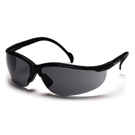 A pair of sleek Pyramex Safety Venture II Safety Glasses with dark-tinted, curved lenses and smooth, wrap-around temples is displayed against a plain white background, providing excellent UV and eye protection.