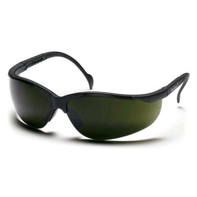 The Pyramex Venture II Welding Safety Glasses SB18_0SF feature a sleek, sporty design with black rims and dark tinted lenses that offer excellent UV protection. These glasses are displayed at an angle on a white background.