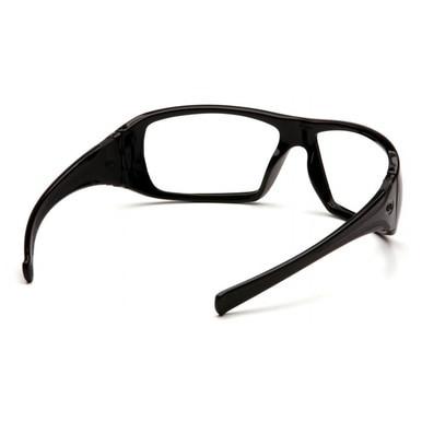 The Pyramex Goliath Safety Glasses, featuring black frames with clear lenses and wraparound arms, are displayed as a perfect addition to your workwear ensemble. Designed by Pyramex Safety, their sleek and solid frame offers optimal eye protection.