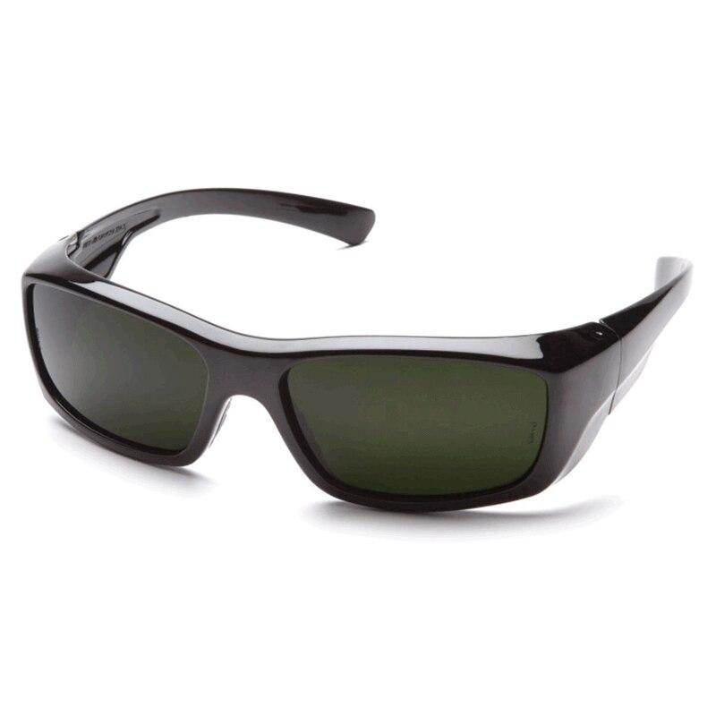 A pair of Pyramex Emerge Welding Safety Glasses with black wraparound frames, dark tinted lenses, and UV protection. The design includes wide arms and a sleek, streamlined look, ideal for outdoor activities.