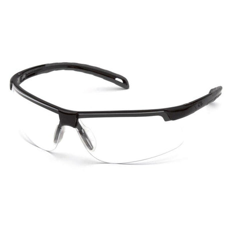 A pair of Pyramex Ever-lite Anti-fog Safety Glasses from Pyramex Safety, with black frames and transparent lenses, rests on a white surface, showcasing a wrap-around design for superior eye and UV protection.