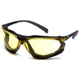 The Pyramex Safety Proximity Glasses H2X Anti-Fog Lens SB93 feature black frames with yellow-tinted, wraparound lenses designed for eye protection. Their sleek, curved design includes flame-resistant foam padding and meets the ANSI Z87+ compliance standards.