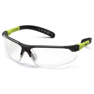 The Pyramex Sitecore Safety Glasses SGL101_0DTM, offered by Pyramex Safety, feature a stylish design with clear, UV-resistant lenses and black frames complemented by green accents on the arms. These glasses have ergonomic nose pads and adjustable ear grips to ensure comfort and a secure fit.