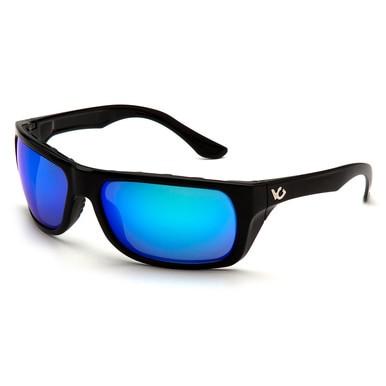 The Pyramex Venture Gear Vallejo Sun Glasses VGSB9 feature high-performance design with black frames and vibrant blue mirrored lenses. The Pyramex Safety brand logo is prominently displayed on both arms. Angled slightly to showcase both the front and side, these sunglasses offer anti-fog, scratch-resistant lenses for ultimate clarity.