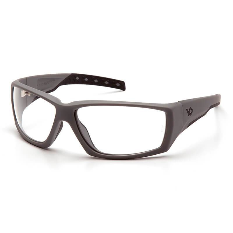 Introducing the Pyramex Venture Gear Overwatch Tactical Glasses in Urban Gray, featuring a contemporary design with sleek rectangular lenses and advanced anti-fog technology. The frames boast a subtle curve with a discreet logo on the temple, and the interior showcases a stylish diamond pattern for added flair and essential UVA/UVB protection.