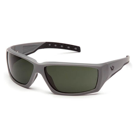 Introducing the Pyramex Safety Venture Gear Overwatch Tactical Glasses in Urban Gray, featuring a sleek design with gray frames and dark tinted lenses. These stylish sunglasses provide UVA and UVB protection and include a subtle logo on the temple, available in a convenient pack of 6.