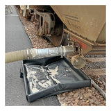 A large hose connected to a train car releases white granules, some of which have spilled onto an UltraTech Pellet Pond 8859 mat and the rocks on the ground alongside the train tracks.