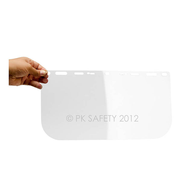 A hand holds the Pyramex Safety S1010 Clear Face Shield Visor Replacement, a rectangular shield with rounded corners and top slots—ideal as essential safety equipment.