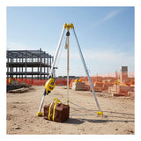A French Creek Production 7' Tripod 3-Way Rescue Unit with Bag (R50GTP7) stands ready on a construction site, surrounded by dirt, orange safety fencing, and a partially built steel structure in the background.