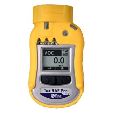 A RAE Systems ToxiRAE Pro PID for Volatile Organic Compounds (VOCs), in yellow, displays "VOC" at 0.0 ppm on its screen. The device features buttons below the display and a black-and-white logo that reads "RAE Systems.