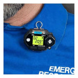 Clipped to the blue shirt of a person is an RKI Instruments GasWatch 3 O2 Single Gas Monitor (model number 72-0012). The device displays "O2" and "20.9," indicating it is functioning continuously. The shirt also has the partial text "EMERG RESPON" in white letters.