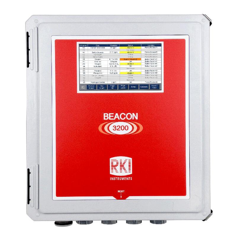 The RKI Beacon 3200 Thirty Two Channel Wall Mount Controller 72-2132 is a red and gray rectangular device featuring a digital display with the "RKI Instruments" branding. Designed for wall mounting, it functions as a gas detection controller, displaying data in columns and rows, with multiple connection ports situated at the bottom.