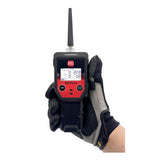 A person wearing a gray and black glove holds an RKI Instruments GX-Force Sample Draw 4 Gas Monitor 72-FA-A-A10, perfect for leak investigations. The device includes an antenna, front-facing control buttons, and clearly displays readings on its screen, ensuring safety in confined spaces.