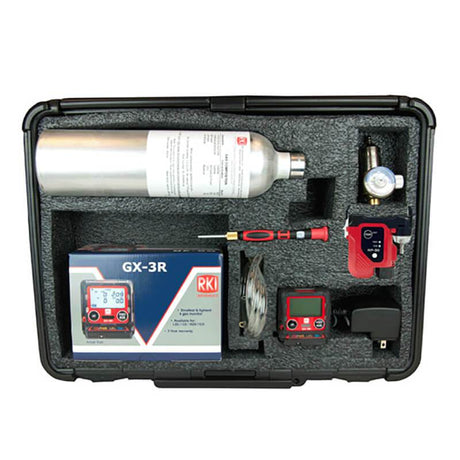 The RKI GX-3R 4 Gas Confined Space Kit by RKI Instruments, ideal for use in confined spaces, is packaged in a black foam case and includes a gas cylinder, digital monitors, tubing, a screwdriver, and a charger. This compact solution is essential for safety needs.