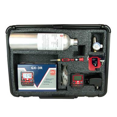 The RKI Instruments GX-3R 4 Gas Confined Space Kit is equipped with a GX-3R gas monitor for confined space detection, housed in a black carrying case, and includes two digital devices with screens, a screwdriver, a charger, and connecting cables.